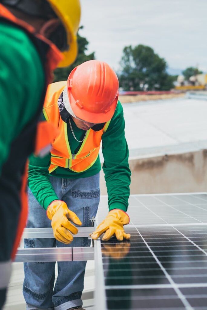 Mastering the First Impression: Your intriguing post title goes here Worker in safety gear installing solar panels on a rooftop.